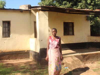 7.4b A happy landlady infront of one of her houses